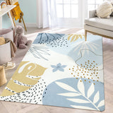 Covaba modern botanical leaf area rug in stormy blue, styled in a room setting, view 14