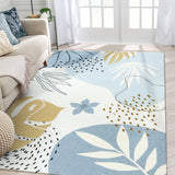 Covaba modern botanical leaf area rug in stormy blue, styled in a room setting, view 11