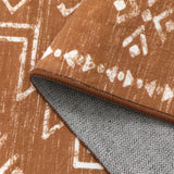 Covaba aztec moroccan distressed rug in amber clay, styled in a room setting