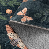 Covaba boho insect botanical floral rug in ink black, styled in a room setting