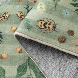 Covaba boho insect botanical floral rug in fern green, styled in a room setting