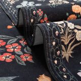 Covaba meadow floral area rug in ink black, styled in a room setting, view 12