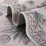 Covaba meadow floral area rug in blush clay, styled in a room setting, view 13