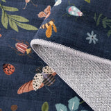 Covaba boho insect botanical floral rug in stormy blue, styled in a room setting, view 2