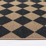 Covaba geometric checkered easy jute indoor/outdoor rug in ink black, styled in a room setting