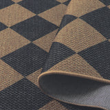 Covaba geometric checkered easy jute indoor/outdoor rug in stormy blue, styled in a room setting
