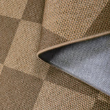 Covaba geometric checkered easy jute indoor/outdoor rug in dune khaki, styled in a room setting