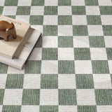 Covaba modern checkerboard rug in olive grove, styled in a room setting