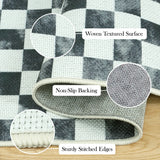 Covaba check soft easy jute black/white indoor/outdoor rug in soft white, styled in a room setting