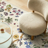 Covaba boho botanical floral rug in warm beige, styled in a room setting