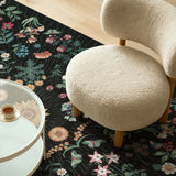 Covaba boho botanical floral rug in ink black, styled in a room setting