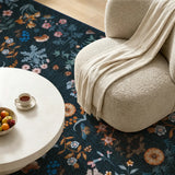 Covaba boho botanical floral rug in stormy blue, styled in a room setting