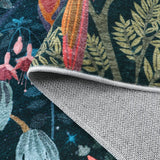 Covaba jungle midnight rug in stormy blue, styled in a room setting