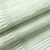 Covaba modern minimalist line rug in fern green, styled in a room setting