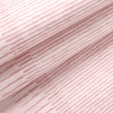 Covaba modern minimalist line rug in blush clay, styled in a room setting