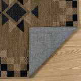 Covaba tribal soft easy jute indoor/outdoor rug in ink black, styled in a room setting