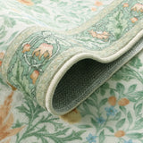 Covaba vintage floral bird rug in willow sage, styled in a room setting