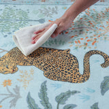 Covaba jungle animals rug in stormy blue, styled in a room setting