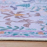 Covaba jungle animals rug in muted plum, styled in a room setting