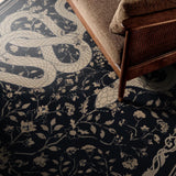 Covaba mystical snake rug in ink black, styled in a room setting, view 2