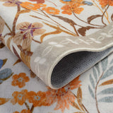 Covaba modern blooming floral garden rug in golden wheat, styled in a room setting