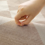 Covaba modern geometric checkered rug in warm beige, styled in a room setting
