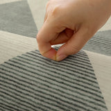 Covaba modern geometric checkered rug in fern green, styled in a room setting