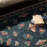 Covaba vintage botanical insect rug in stormy blue, styled in a room setting