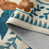 Covaba boho birdsong floral garden rug in warm beige, styled in a room setting, view 2