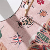 Covaba modern parisian insect rug in blush clay, styled in a room setting