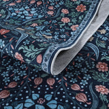 Covaba maximalism vibrant floral rug in stormy blue, styled in a room setting