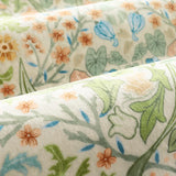 Covaba maximalism vibrant floral rug in sage mist, styled in a room setting