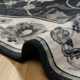 Covaba vintage botanical scalloped rug in ink black, styled in a room setting, view 2