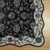 Covaba vintage botanical scalloped rug in ink black, styled in a room setting