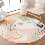 Covaba modern botanical leaf round rug in blush clay, styled in a room setting, view 2