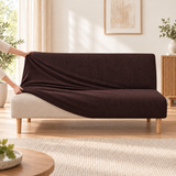 Hands stretching the espresso sofa bed cover over a sofa bed during fitting