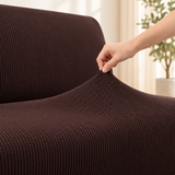 Close up of the espresso smooth knit stretching between two fingers