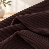 Macro view of the espresso smooth stretch knit texture draped in soft folds