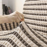 Black & Sand Bubble sofa cover shown across the seat and backrest of a two-seater