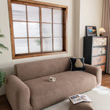 Brown Chenille sofa cover draped over a three-seater sofa in a bright living room, view 2