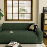 Forest Chenille sofa cover draped over a three-seater sofa in a bright living room, view 4