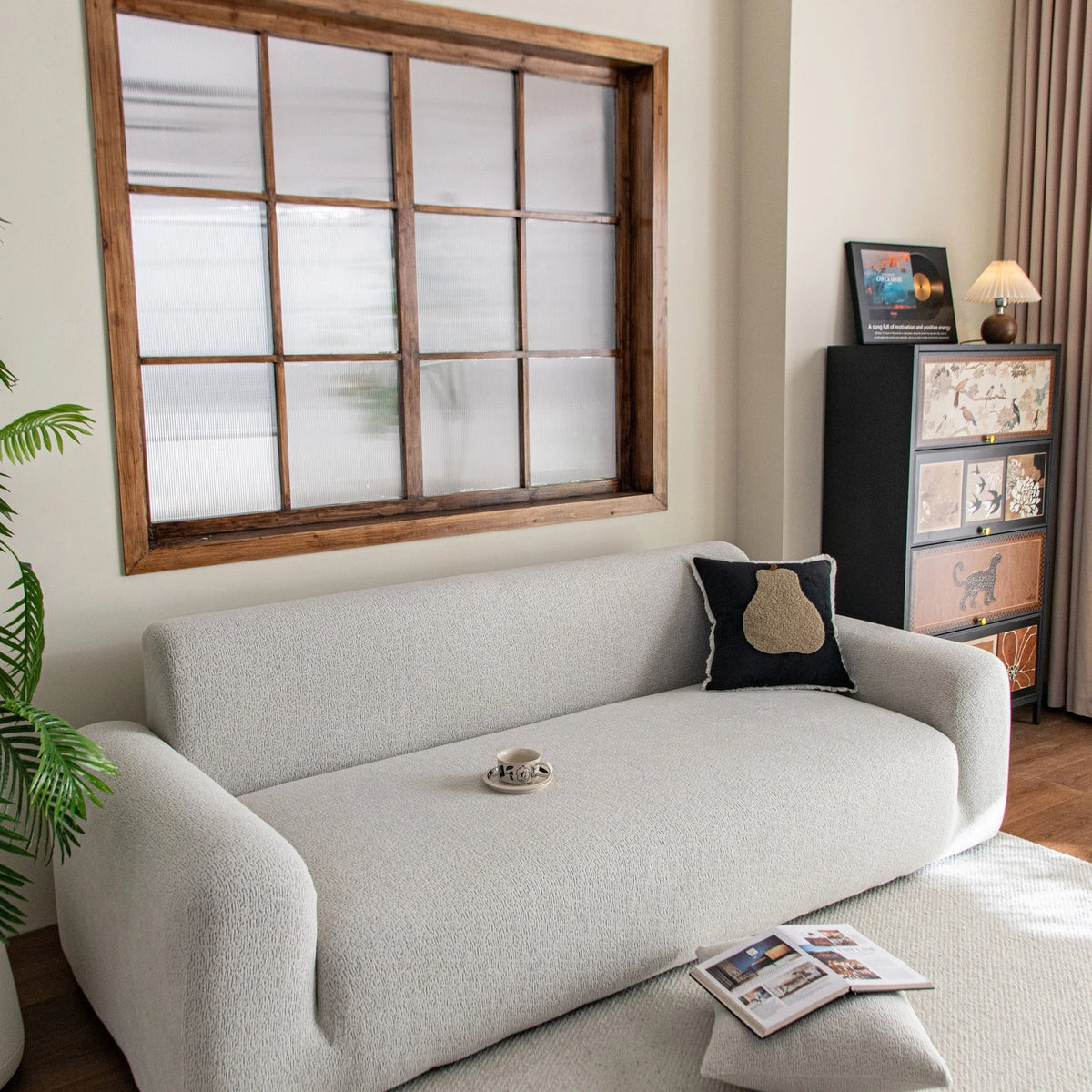 Pearl Grey Chenille sofa cover draped over a three-seater sofa in a bright living room, view 3