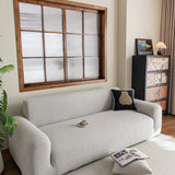 Pearl Grey Chenille sofa cover draped over a three-seater sofa in a bright living room, view 3