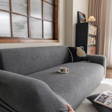 Stone Grey Chenille sofa cover photographed at an angle beside a floor lamp, view 2