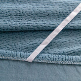 Stormy Blue Chenille sofa cover styled with cushions on a low-back sofa