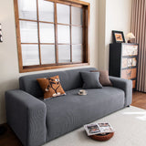 Grey Corduroy sofa cover draped over a three-seater sofa in a bright living room