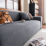 Grey Corduroy sofa cover seen from the side on a corner sofa