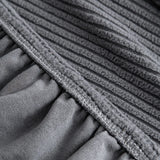 Grey Corduroy sofa cover styled with cushions on a low-back sofa