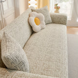 Boucle-Style Sand Jacquard sofa cover draped over a three-seater sofa in a bright living room, view 2