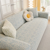 Stormy Blue Jacquard sofa cover draped over a three-seater sofa in a bright living room